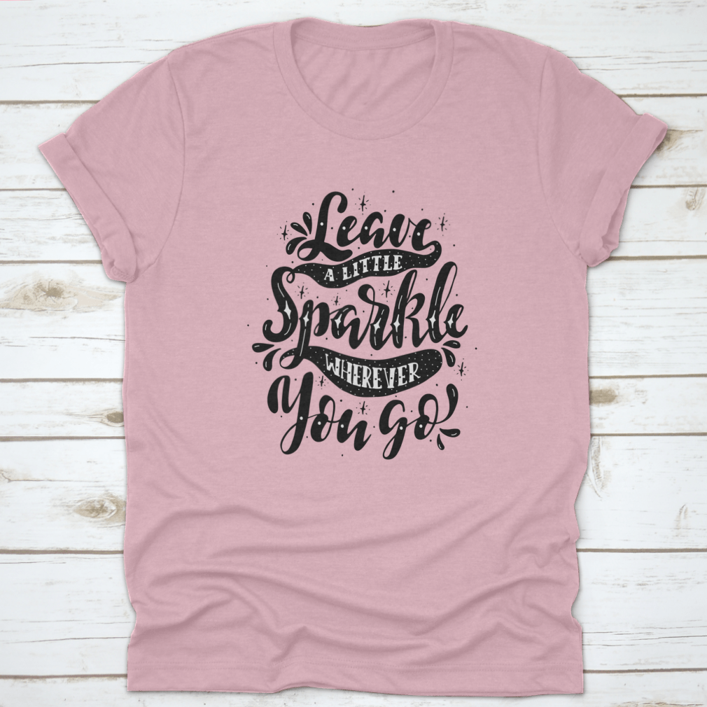 A comfortable and stylish t-shirt featuring the inspirational phrase 'Leave A Little Sparkle Wherever You Go' in a vibrant print.