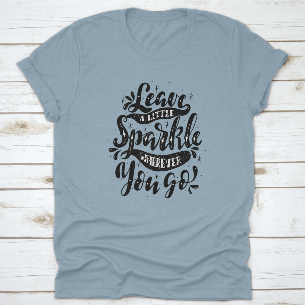 A comfortable and stylish t-shirt featuring the inspirational phrase 'Leave A Little Sparkle Wherever You Go' in a vibrant print.