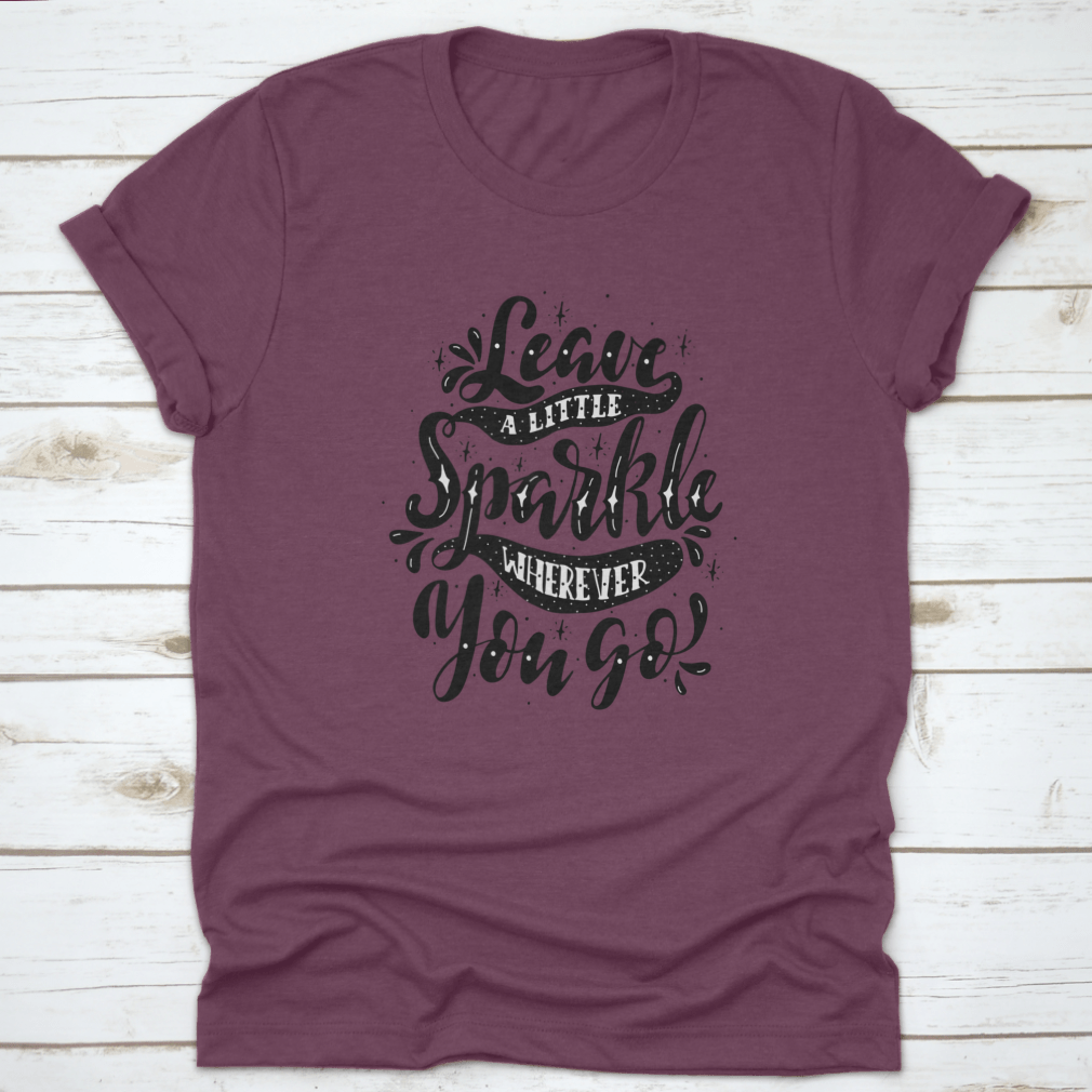 A comfortable and stylish t-shirt featuring the inspirational phrase 'Leave A Little Sparkle Wherever You Go' in a vibrant print.