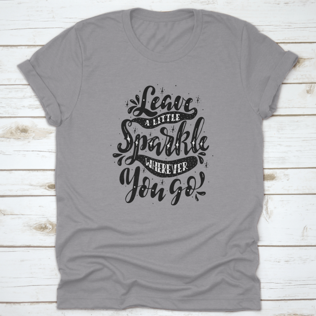 A comfortable and stylish t-shirt featuring the inspirational phrase 'Leave A Little Sparkle Wherever You Go' in a vibrant print.