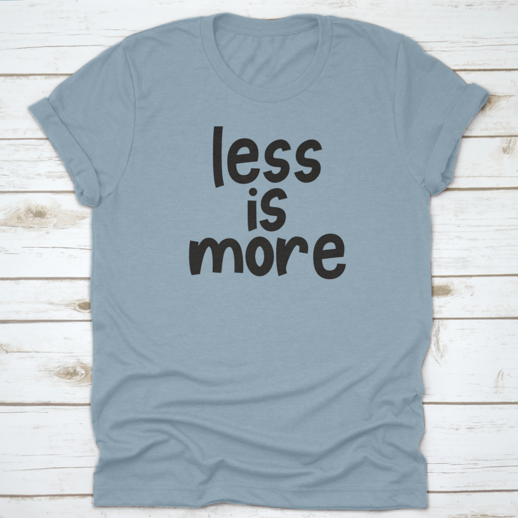 A stylish grey T-shirt featuring the hand-lettered slogan 'Less Is More', promoting zero waste and sustainable fashion.