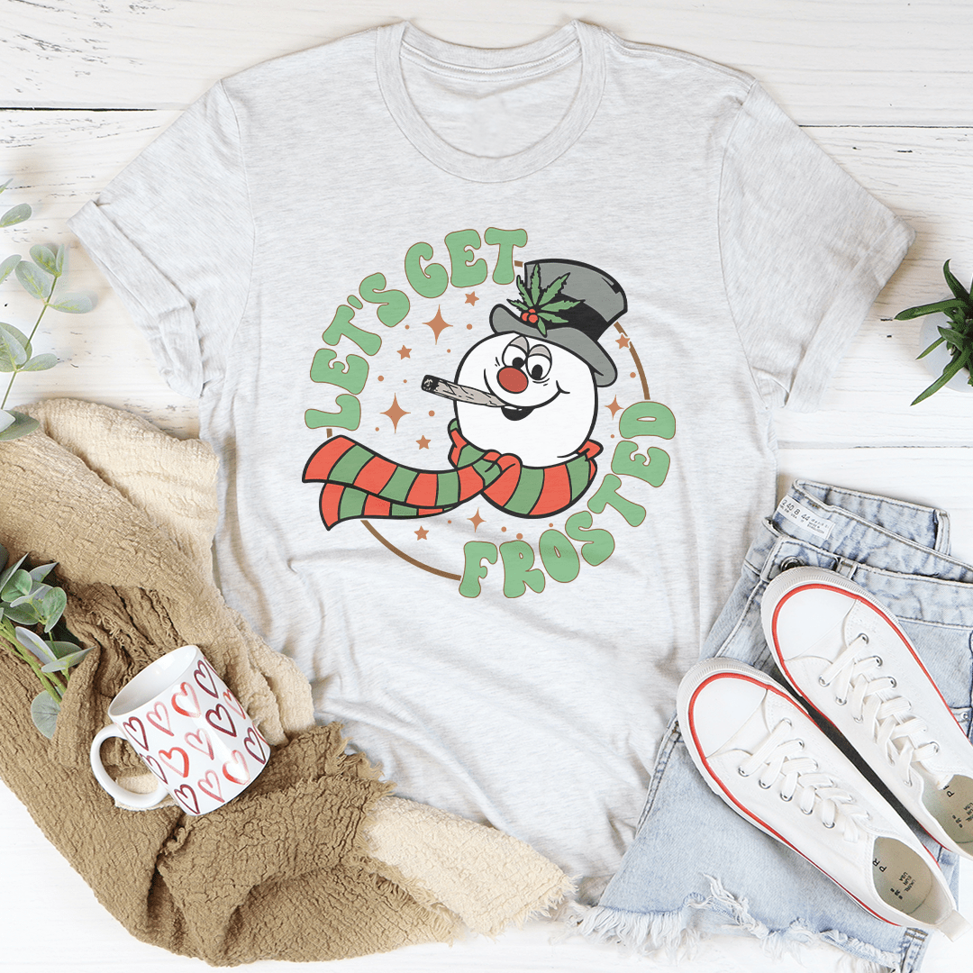 A festive Let's Get Frosted Tee featuring a cheerful Christmas design, made from 100% soft cotton, perfect for holiday celebrations.