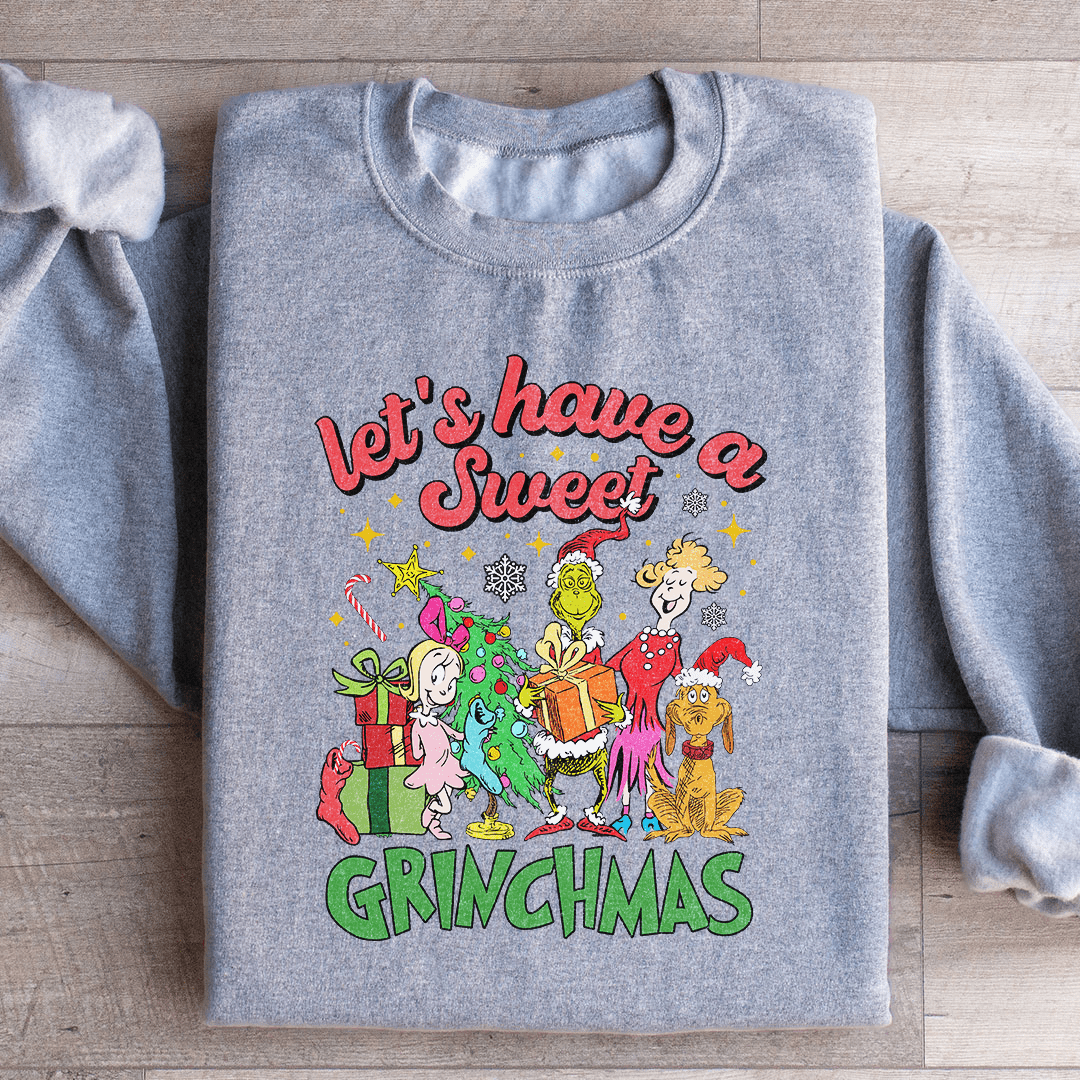 Cozy 'Let's Have A Sweet Grinchmas' sweatshirt featuring festive design and adjustable cuffs, perfect for winter wear.
