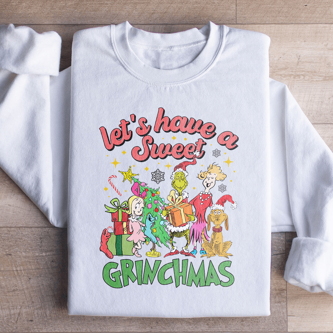 Cozy 'Let's Have A Sweet Grinchmas' sweatshirt featuring festive design and adjustable cuffs, perfect for winter wear.