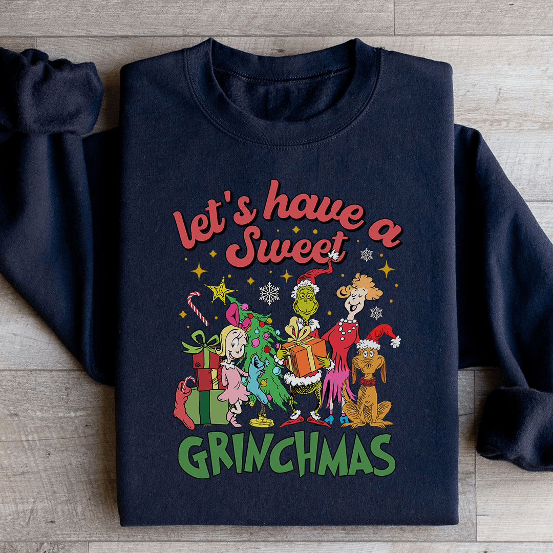 Cozy 'Let's Have A Sweet Grinchmas' sweatshirt featuring festive design and adjustable cuffs, perfect for winter wear.