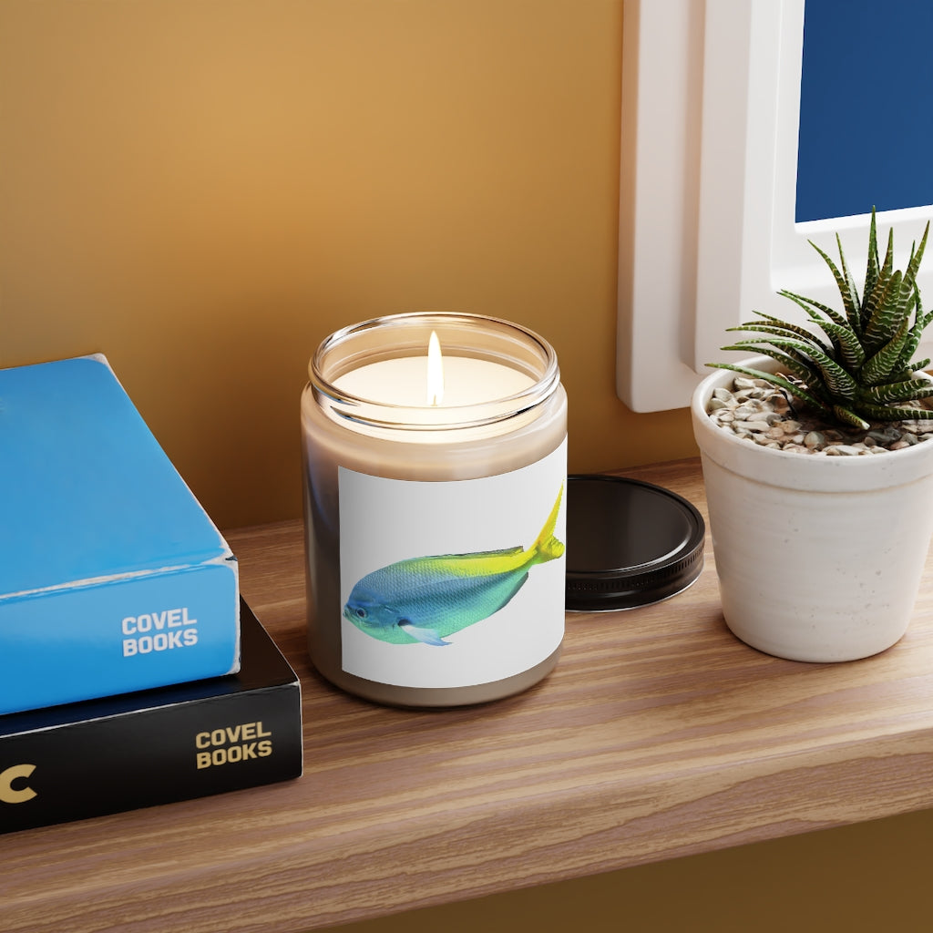 Light Blue and Yellow Fish Scented Candle in a glass container, showcasing its vibrant colors and elegant design.