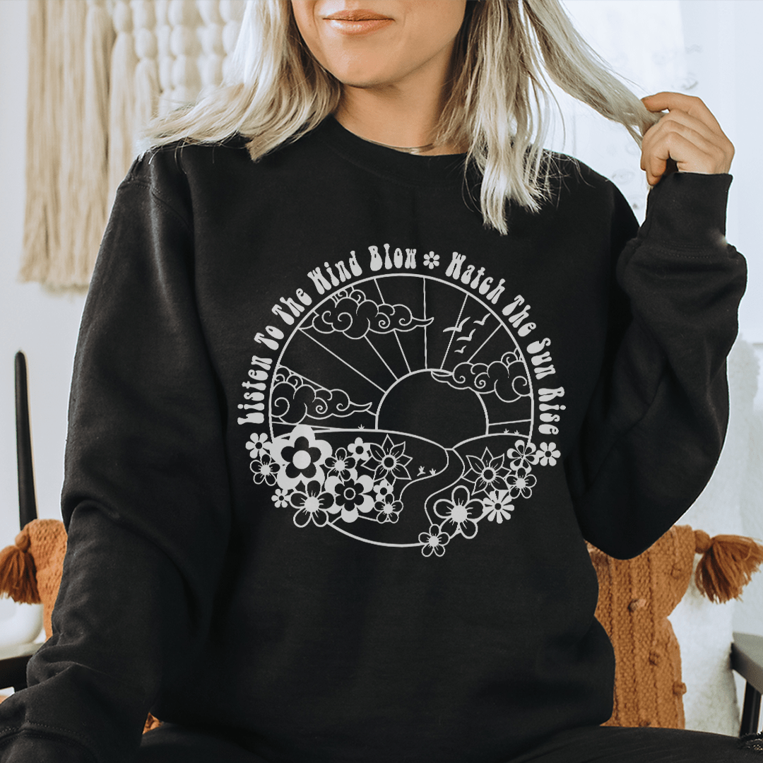 A cozy hoodie featuring the design 'Listen To The Wind Blow', made from a soft cotton/poly fleece blend, perfect for casual wear.