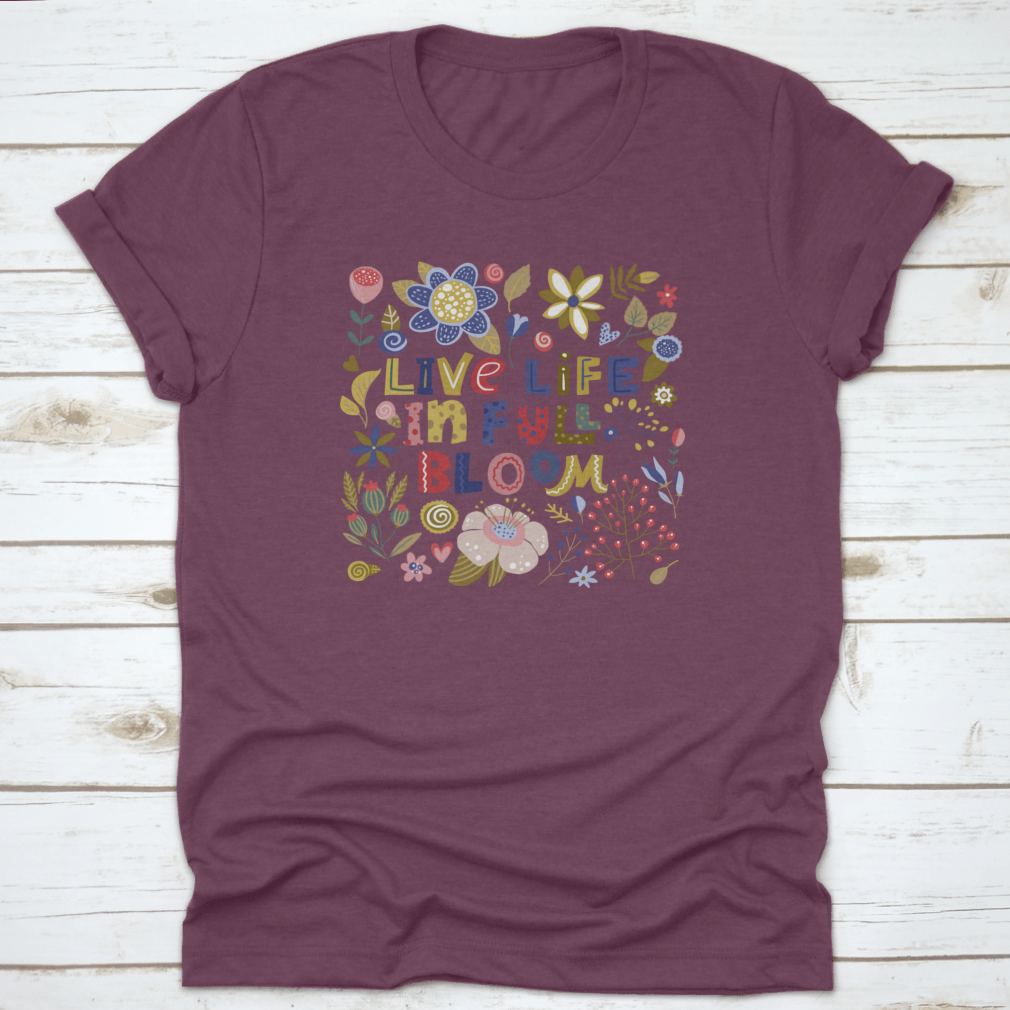 A stylish t-shirt featuring the motivational quote 'Live Life In Full Bloom' designed with vibrant colors and a classic fit, perfect for inspiring positivity.
