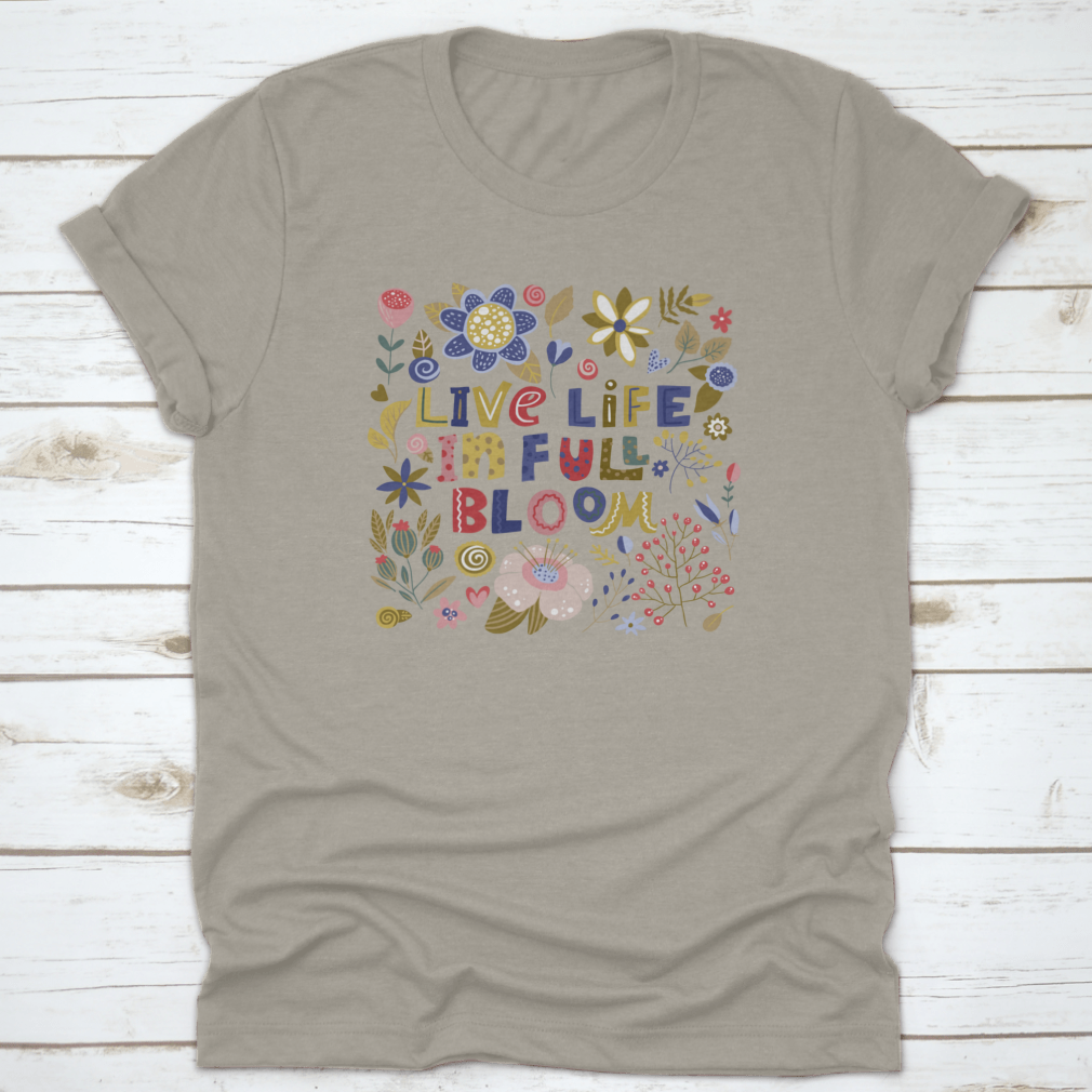 A stylish t-shirt featuring the motivational quote 'Live Life In Full Bloom' designed with vibrant colors and a classic fit, perfect for inspiring positivity.