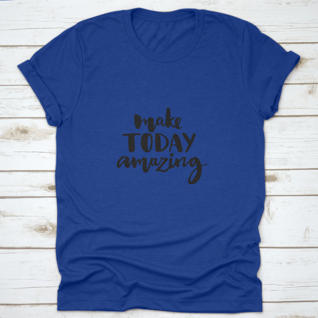 A stylish shirt featuring the handwritten inspirational quote 'Make Today Amazing' in black ink on a soft fabric background.