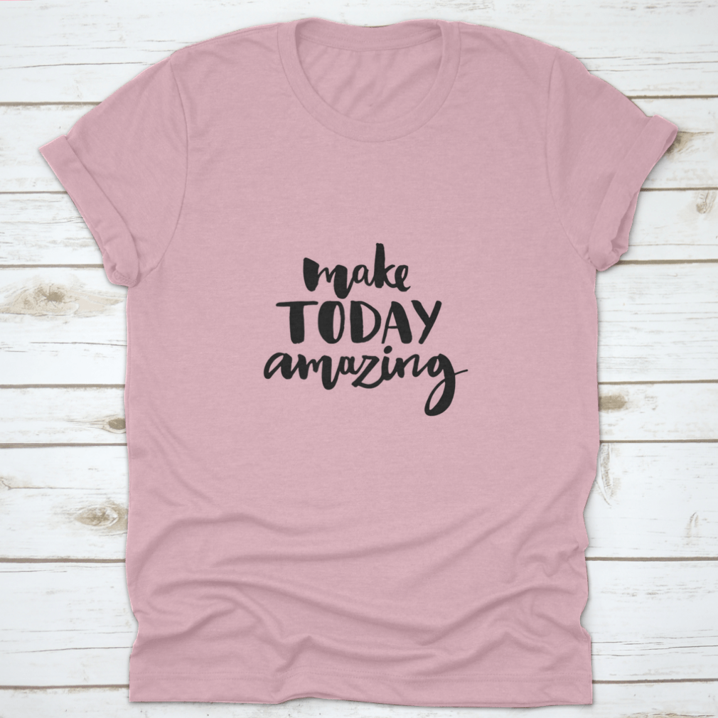 A stylish shirt featuring the handwritten inspirational quote 'Make Today Amazing' in black ink on a soft fabric background.