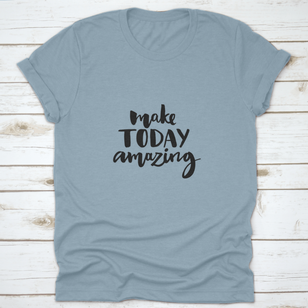 A stylish shirt featuring the handwritten inspirational quote 'Make Today Amazing' in black ink on a soft fabric background.