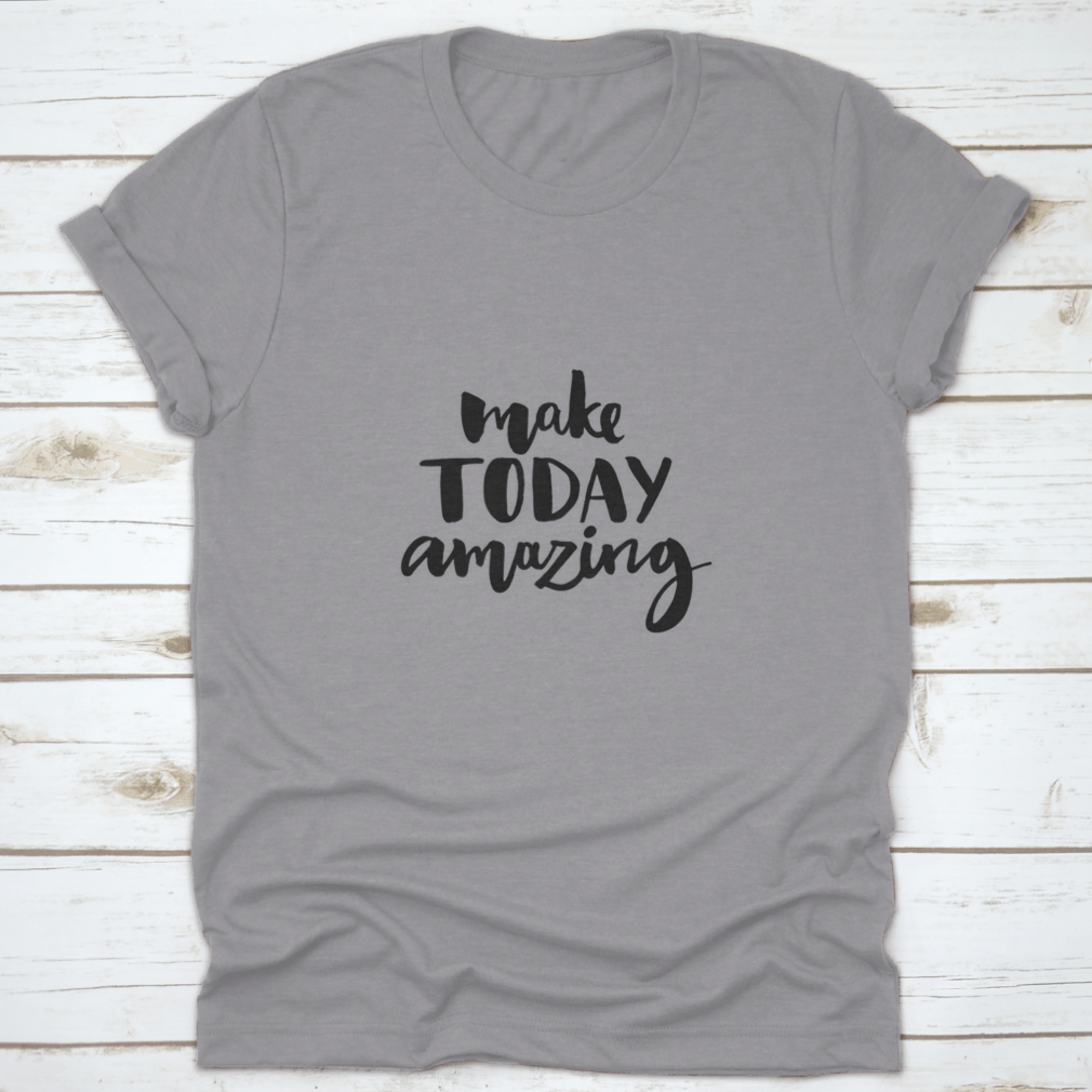 A stylish shirt featuring the handwritten inspirational quote 'Make Today Amazing' in black ink on a soft fabric background.