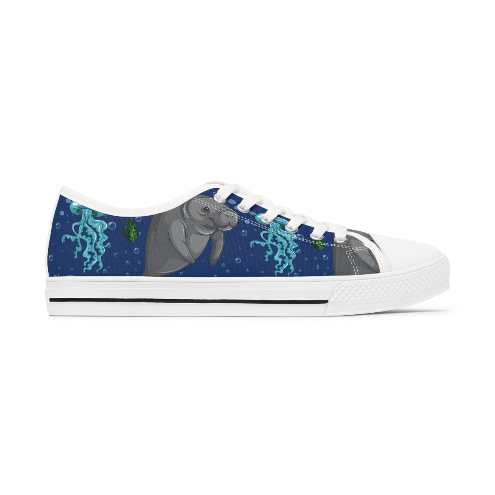A pair of stylish Manatee Women's Low Top Sneakers in black and white, showcasing breathable canvas and memory foam insoles.