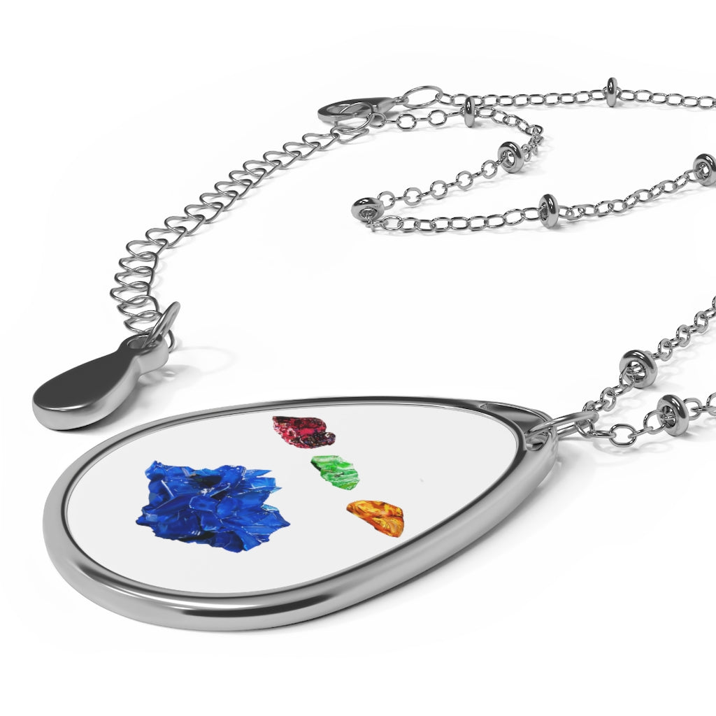 A stylish Minerals Oval Necklace featuring a unique ellipse-shaped brass pendant with a white print base and a secure lobster clasp closure.