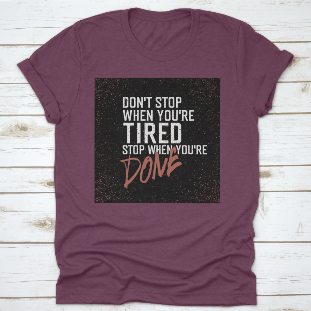 Motivational poster with the quote 'Don't Stop When You're Tired. Stop When You're Done.' displayed in a modern setting.