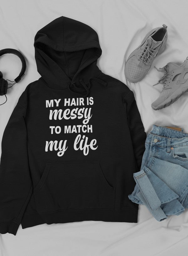 A cozy hoodie featuring the phrase 'My Hair Is Messy To Match My Life', designed by top artists, showcasing a stylish and comfortable fit.