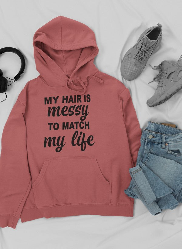 A cozy hoodie featuring the phrase 'My Hair Is Messy To Match My Life', designed by top artists, showcasing a stylish and comfortable fit.