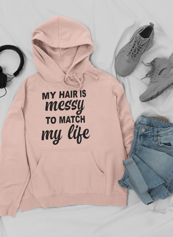 A cozy hoodie featuring the phrase 'My Hair Is Messy To Match My Life', designed by top artists, showcasing a stylish and comfortable fit.