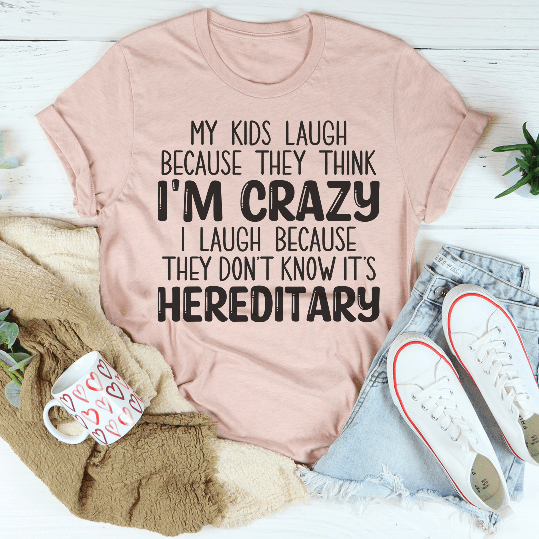 A humorous t-shirt featuring the phrase 'My Kids Laugh Because They Think I'm Crazy I Laugh Because They Don't', made from soft cotton.