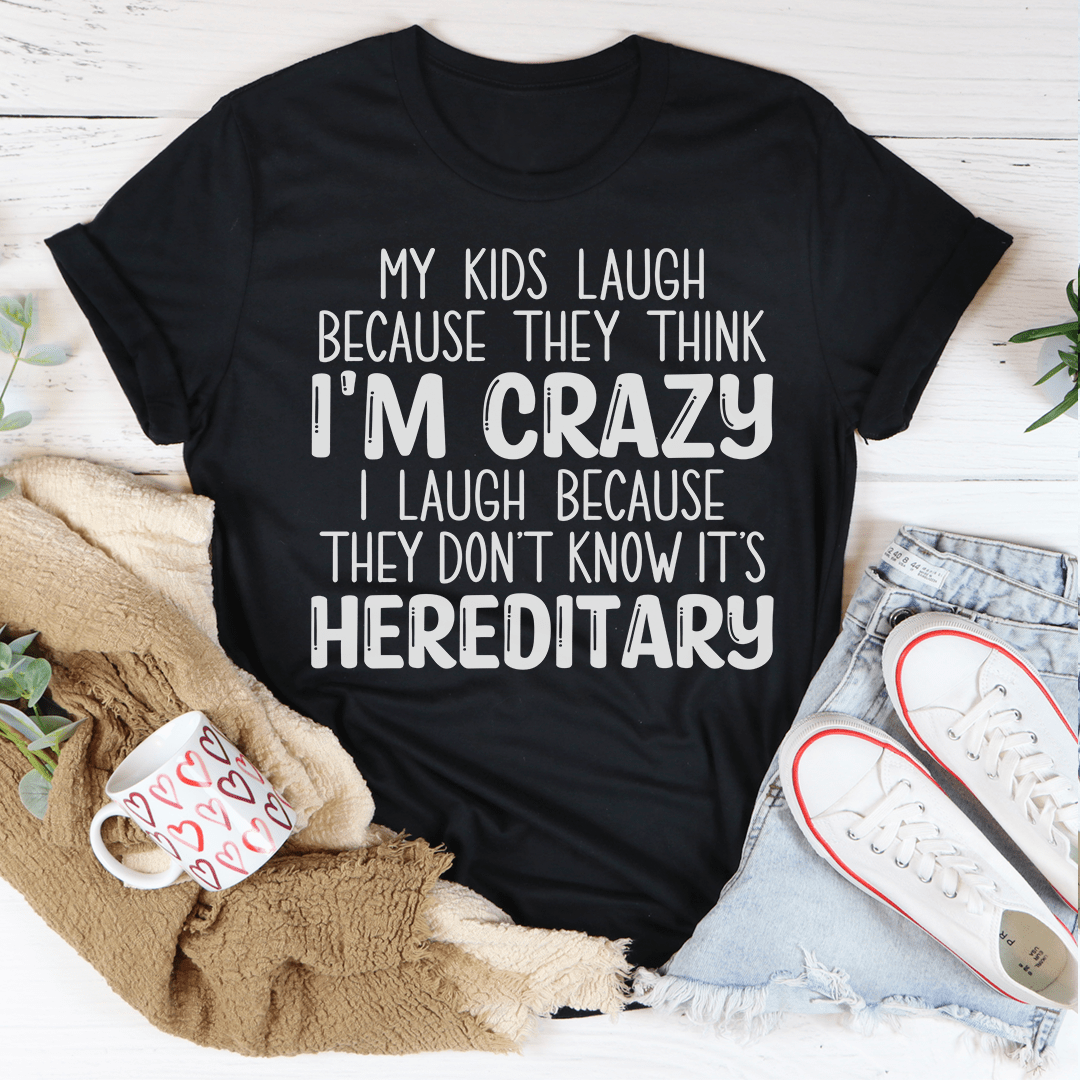 A humorous t-shirt featuring the phrase 'My Kids Laugh Because They Think I'm Crazy I Laugh Because They Don't', made from soft cotton.