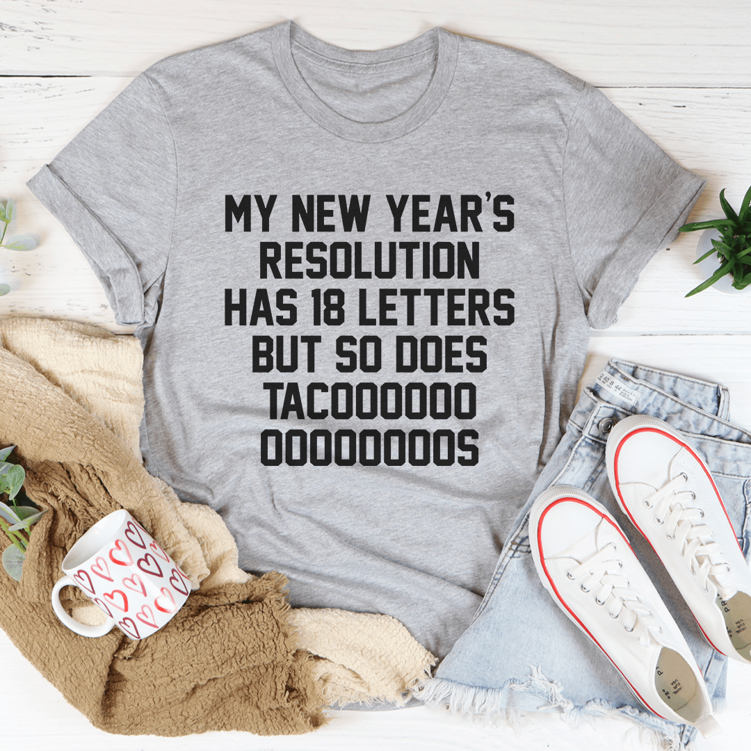A festive New Year's Resolution Tacos Tee featuring a vibrant taco design, made from 100% soft cotton, perfect for holiday celebrations.