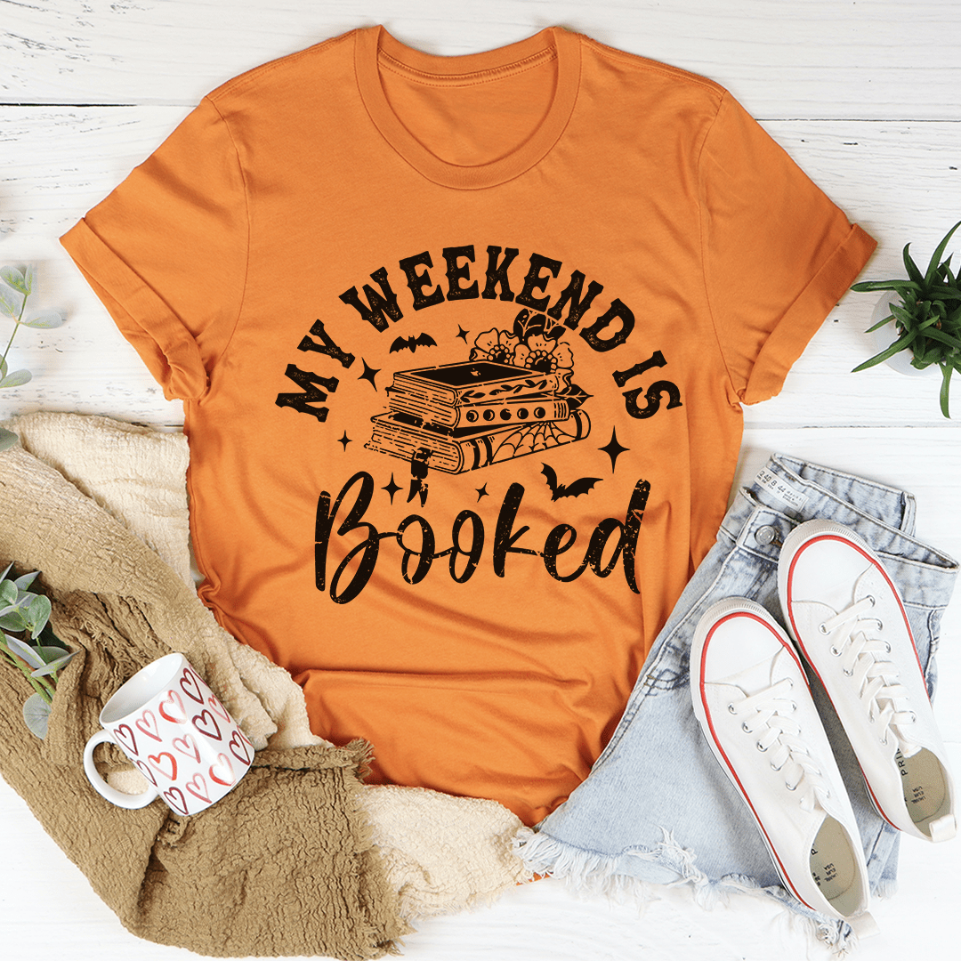 My Weekend Is Booked Tee featuring vibrant Halloween-themed digital print on soft cotton fabric.