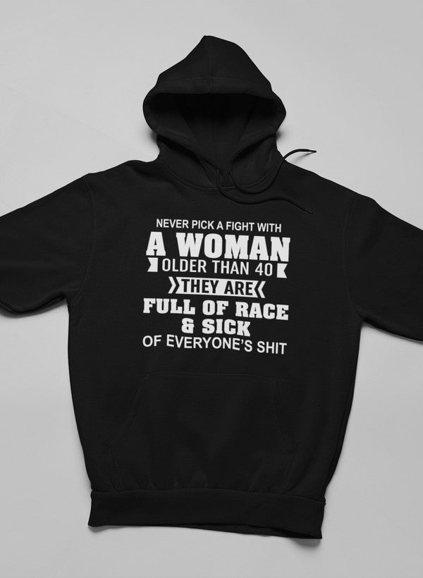 A stylish hoodie featuring the phrase 'Never Pick A Fight With A Woman Older Than 40', made from soft cotton/poly fleece blend.