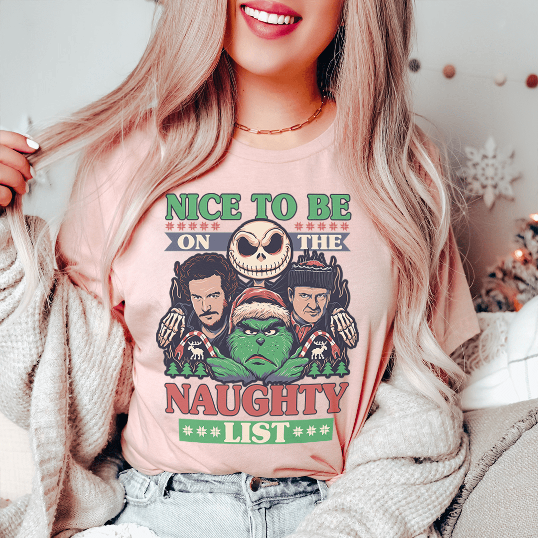 A festive Christmas-themed tee featuring the phrase 'Nice To Be On The Naughty List', made from 100% soft cotton.