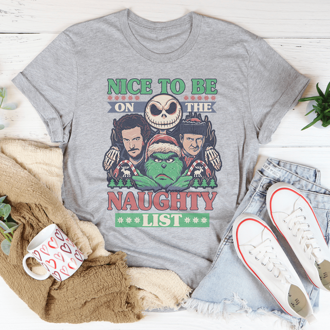 A festive Christmas-themed tee featuring the phrase 'Nice To Be On The Naughty List', made from 100% soft cotton.