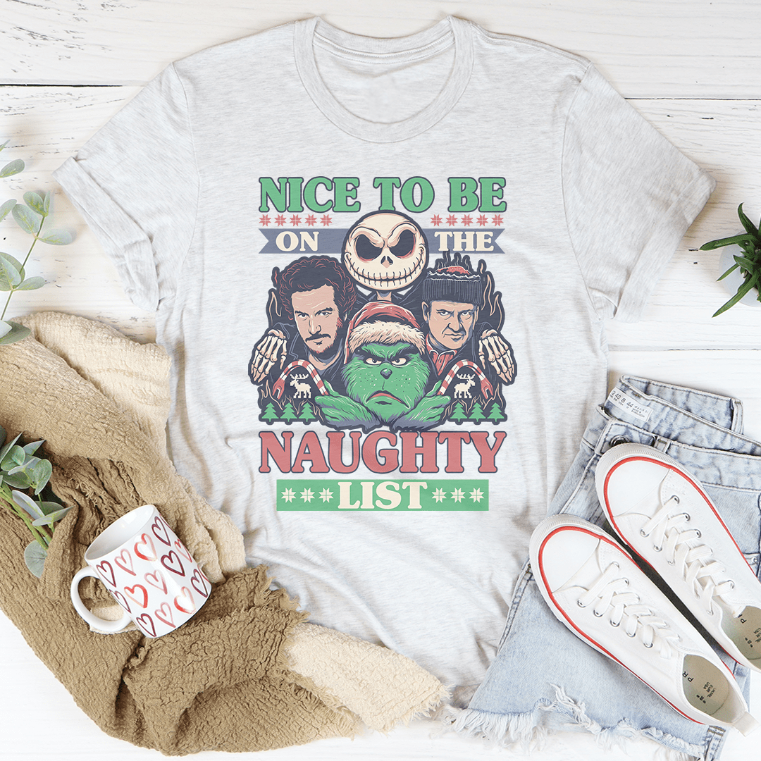 A festive Christmas-themed tee featuring the phrase 'Nice To Be On The Naughty List', made from 100% soft cotton.