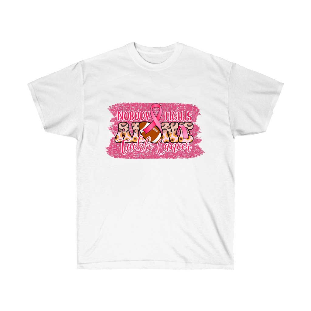 A pink t-shirt with the text 'Nobody Fights Alone' and a football graphic, symbolizing support for cancer awareness.