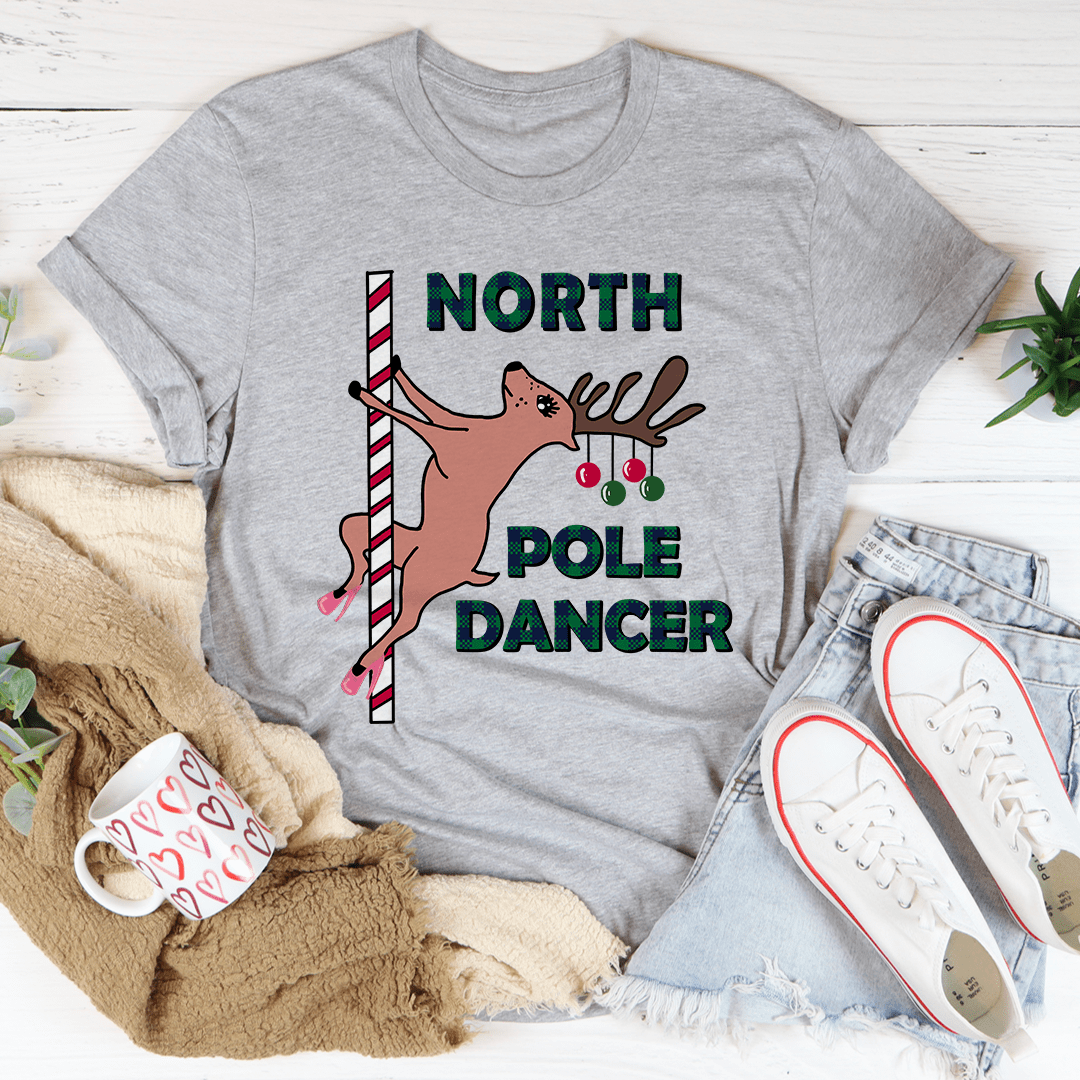 North Pole Dancer Tee featuring festive design, made from 100% soft cotton, perfect for holiday celebrations.