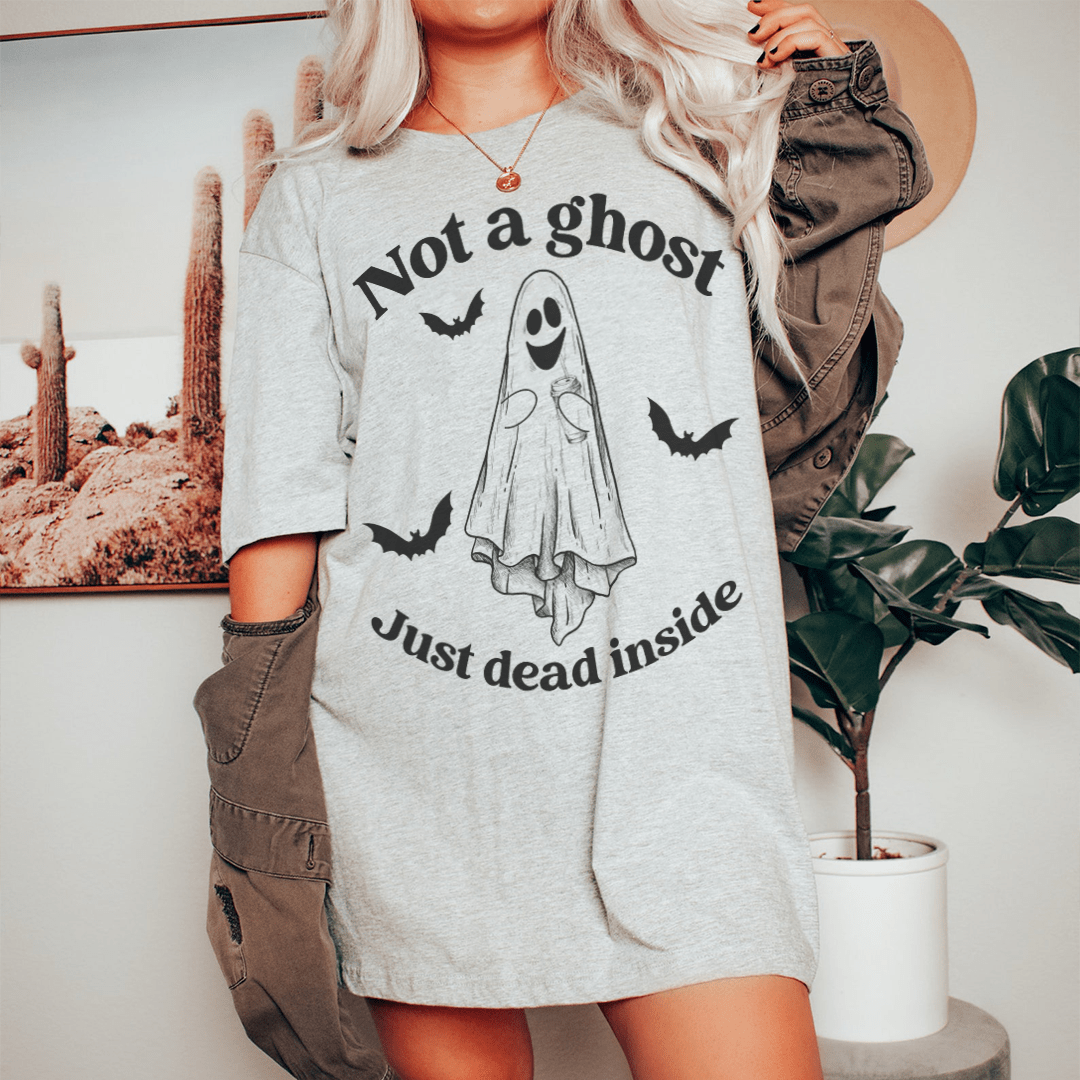 A black Halloween tee featuring the phrase 'Not A Ghost Just Dead Inside' in spooky font, made from 100% soft cotton.