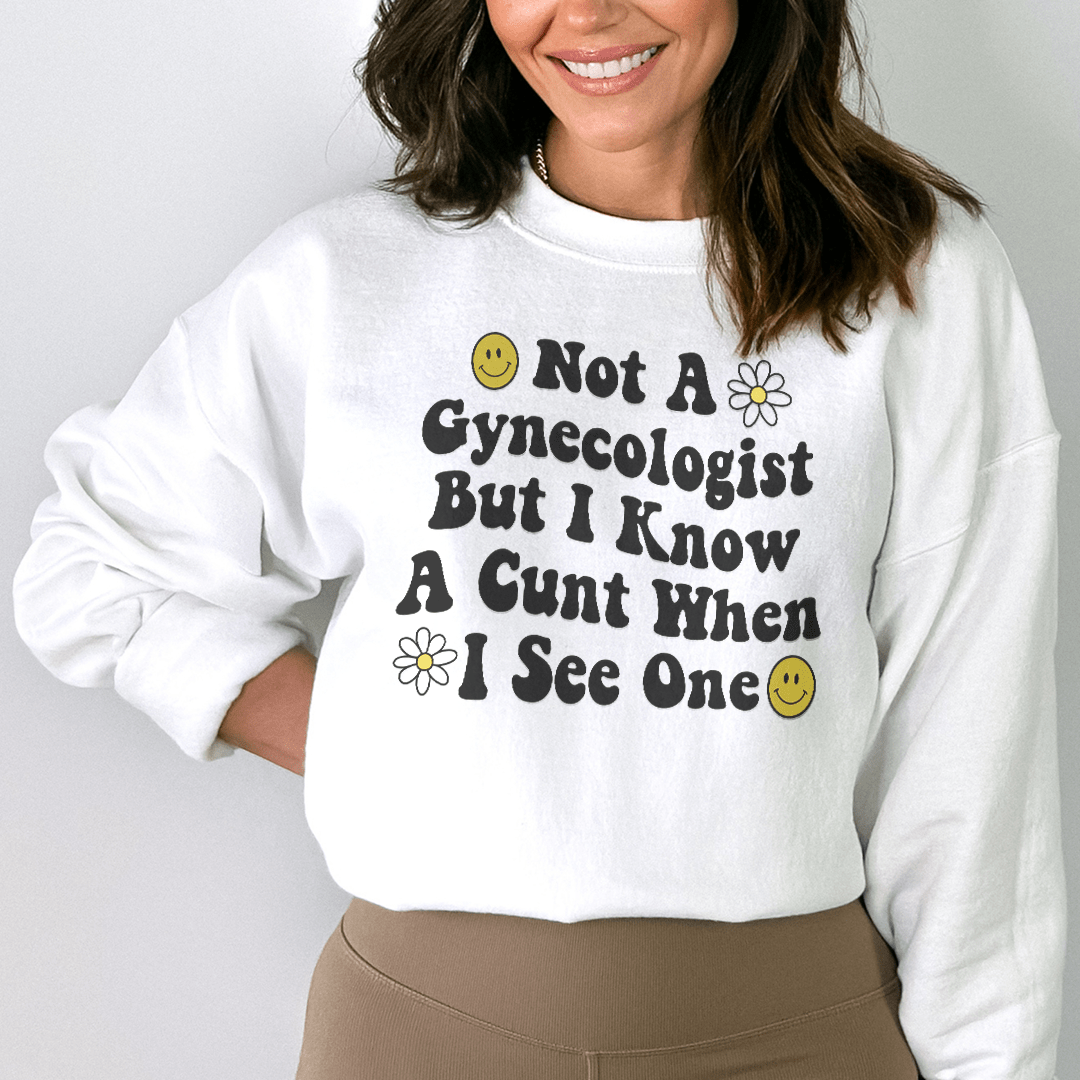 A cozy hoodie with a humorous design that reads 'Not A Gynecologist But I Know A Cunt When I See One', featuring adjustable cuffs and fleece lining.