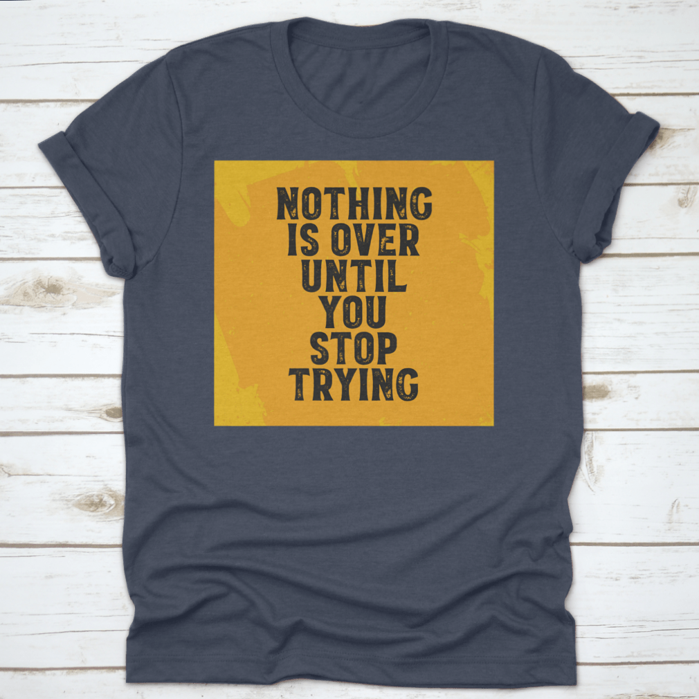 A motivational T-shirt featuring the quote 'Nothing Is Over Until You Stop Trying', made from 100% cotton with a classic fit.