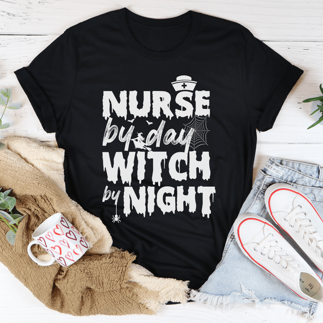 A black t-shirt featuring the phrase 'Nurse By Day Witch By Night' in stylish lettering, showcasing a blend of professionalism and mystique.