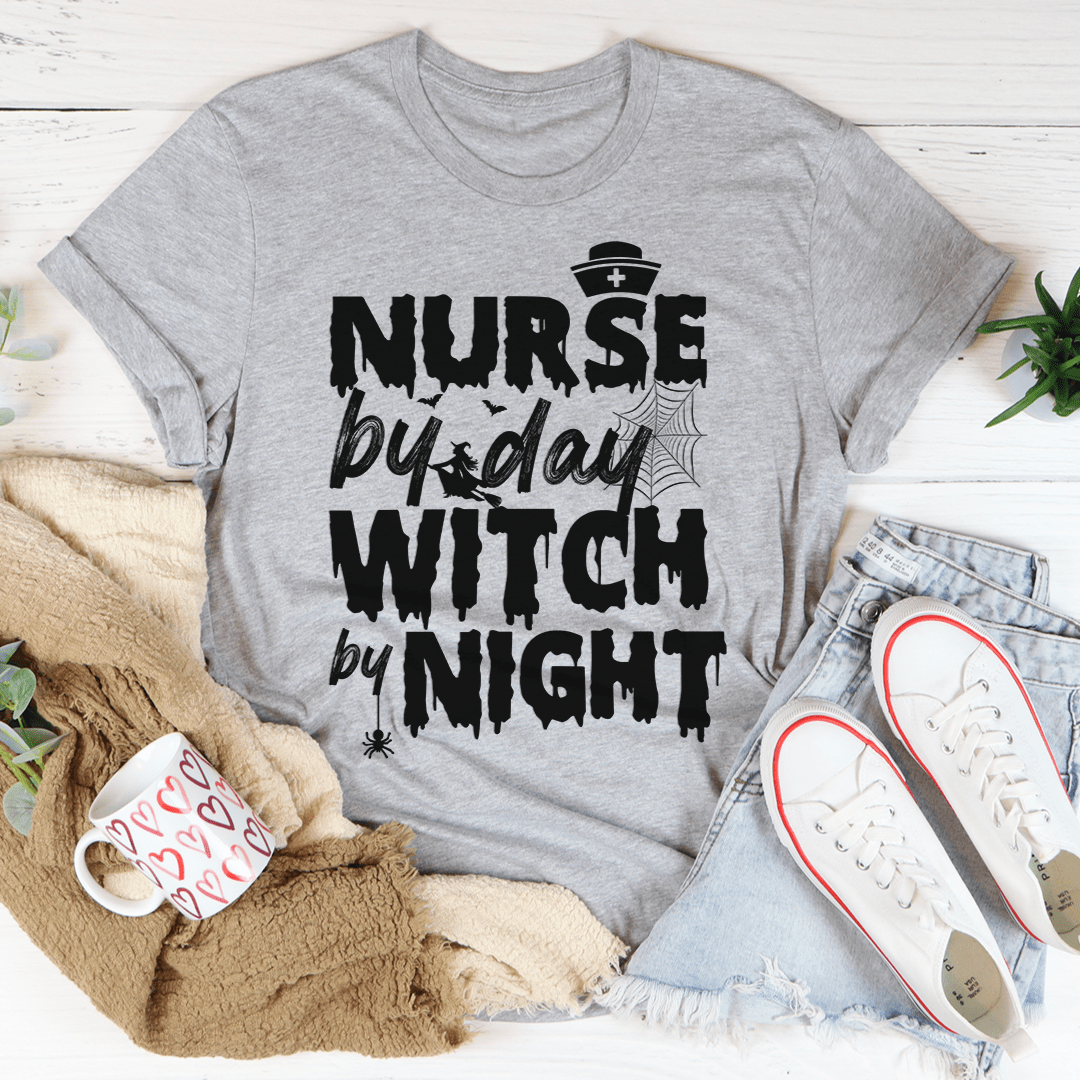 A black t-shirt featuring the phrase 'Nurse By Day Witch By Night' in stylish lettering, showcasing a blend of professionalism and mystique.