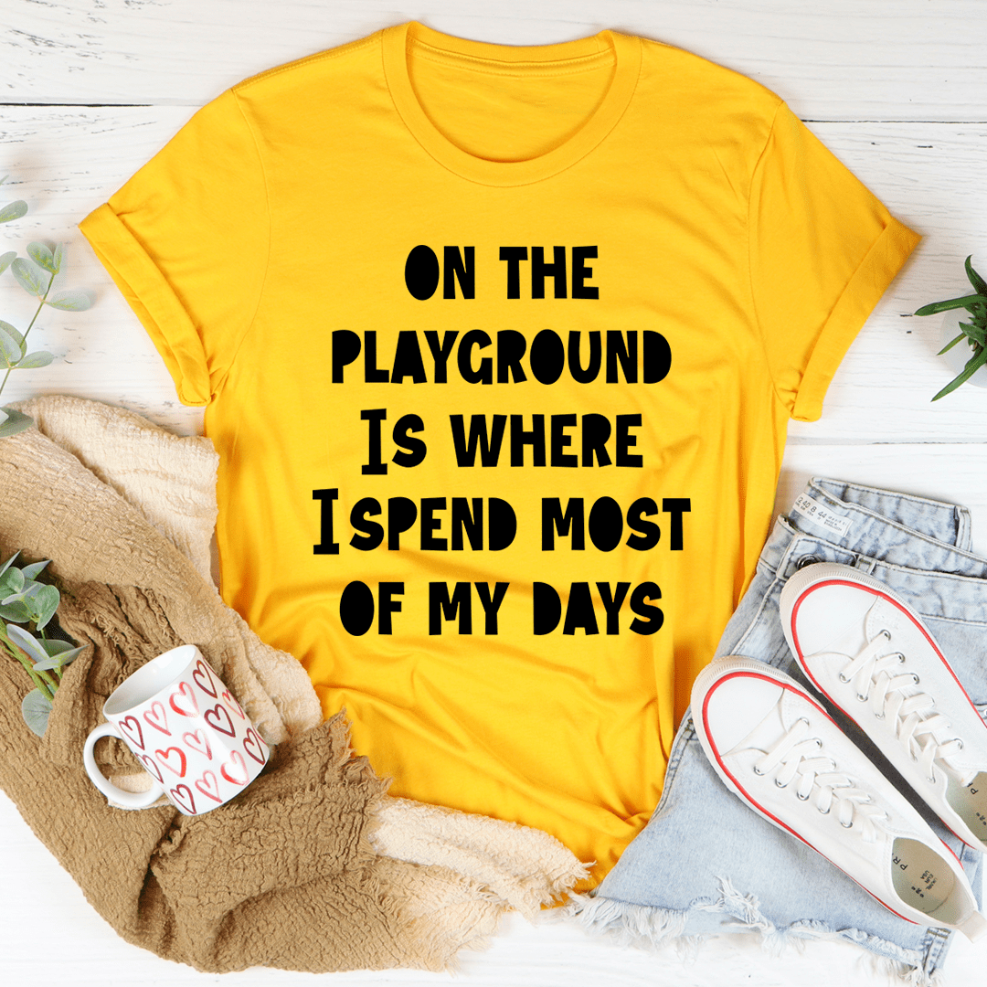 A comfortable and stylish t-shirt featuring the phrase 'On The Playground Is Where I Spend Most Of My Days', made from soft ring-spun cotton.