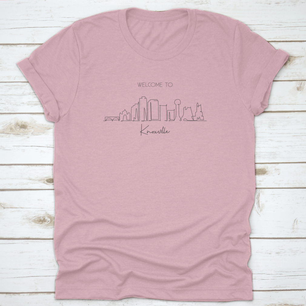 A stylish T-shirt featuring a minimalist one-line drawing of the Knoxville City Skyline, showcasing its iconic buildings.
