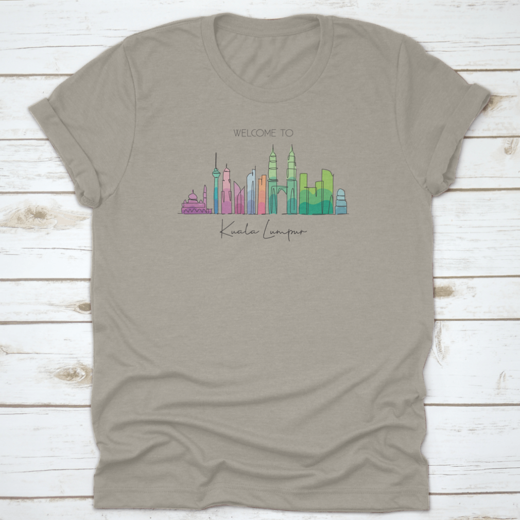 A stylish t-shirt featuring a minimalist single line drawing of the Kuala Lumpur city skyline, showcasing iconic buildings.