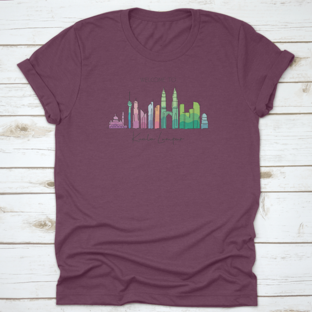 A stylish t-shirt featuring a minimalist single line drawing of the Kuala Lumpur city skyline, showcasing iconic buildings.