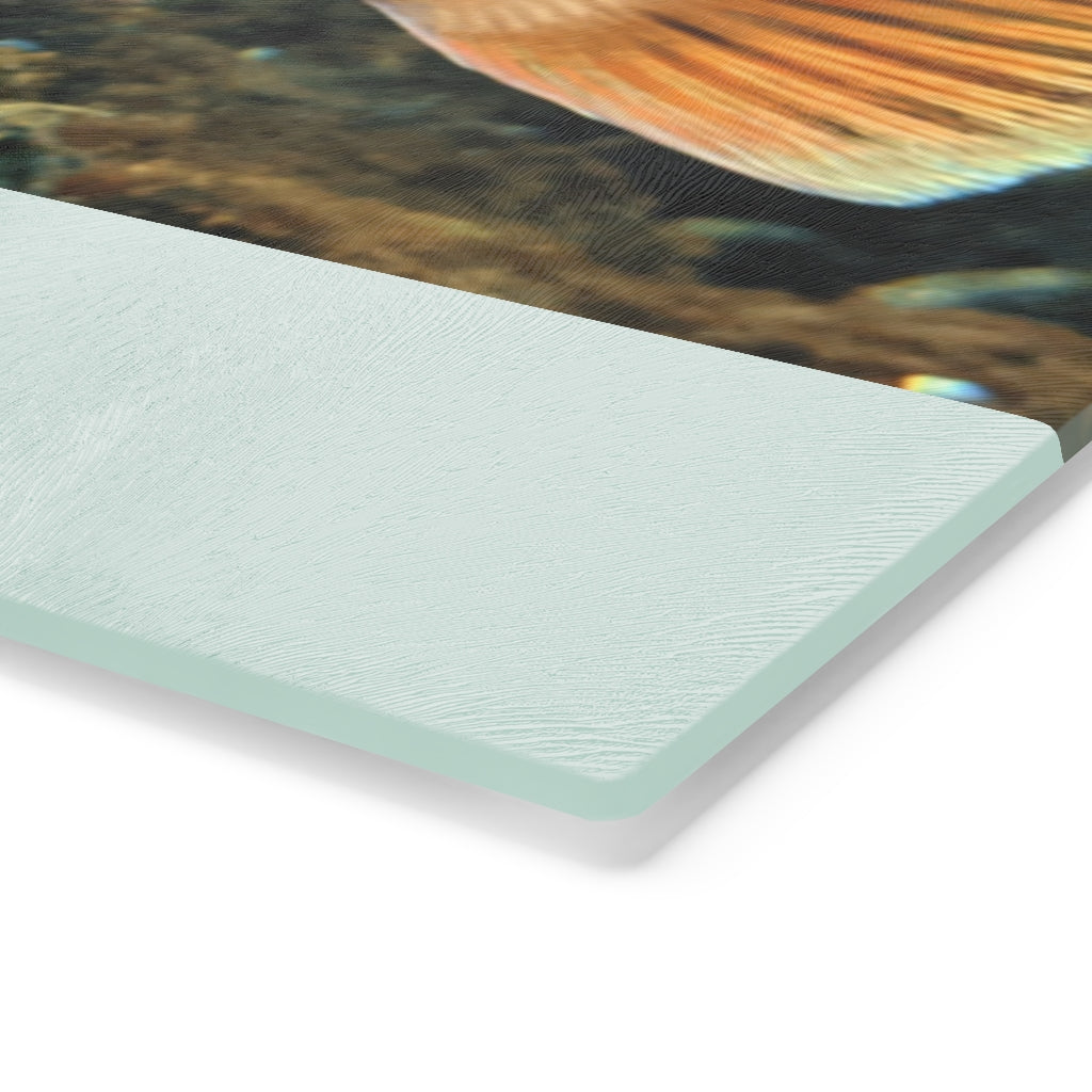 Orange Fish Cutting Board made of tempered glass with rubber dots for stability, featuring a vibrant fish design.