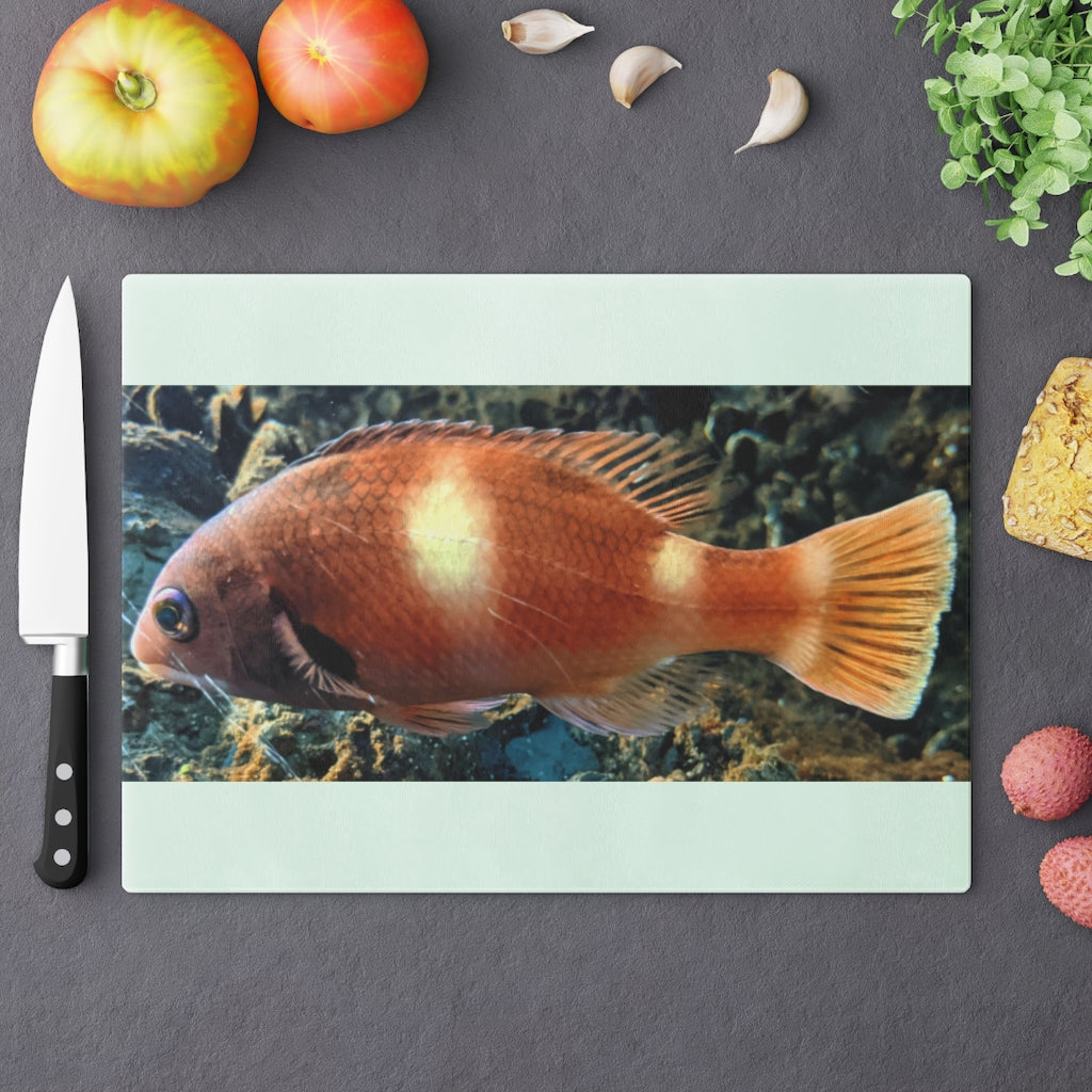 Orange Fish Cutting Board made of tempered glass with rubber dots for stability, featuring a vibrant fish design.