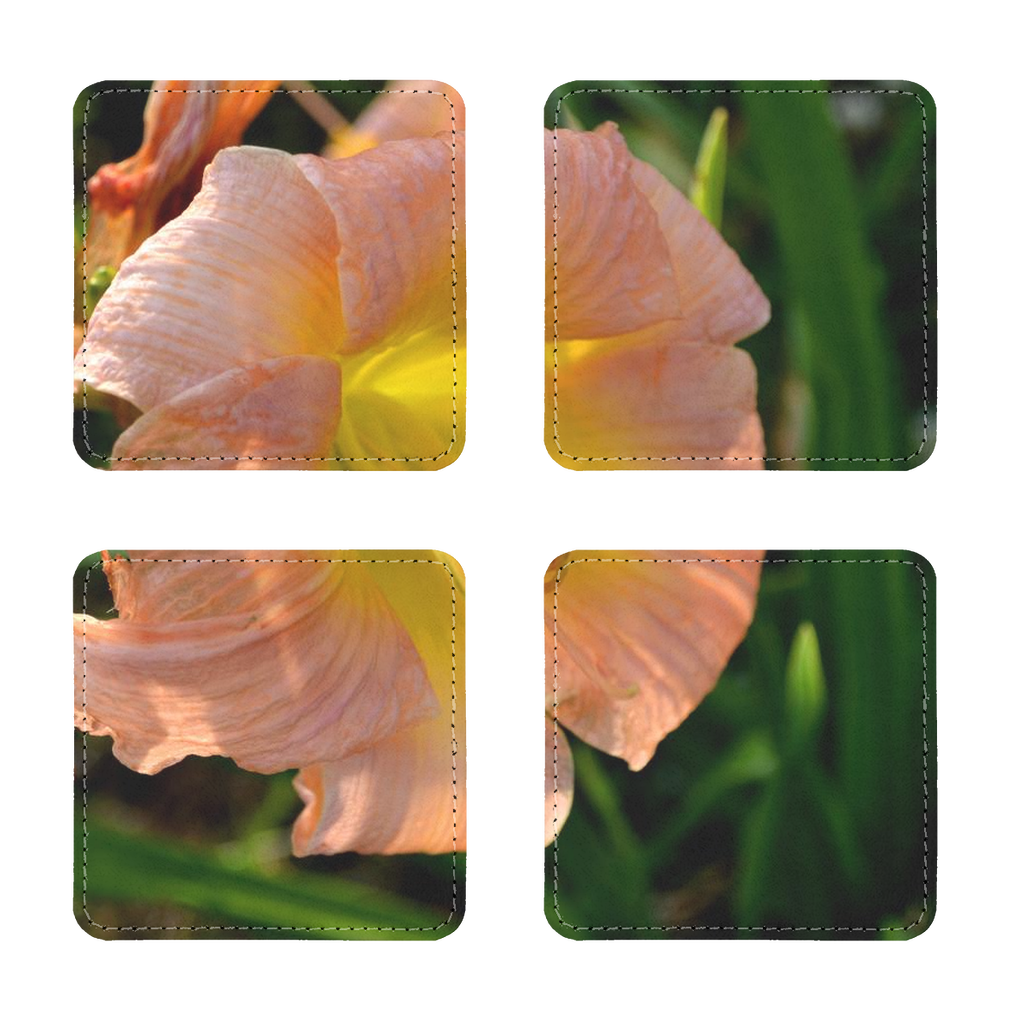 Pack of four orange flower sublimation coasters made of PU leather, showcasing square and round shapes with white stitching.