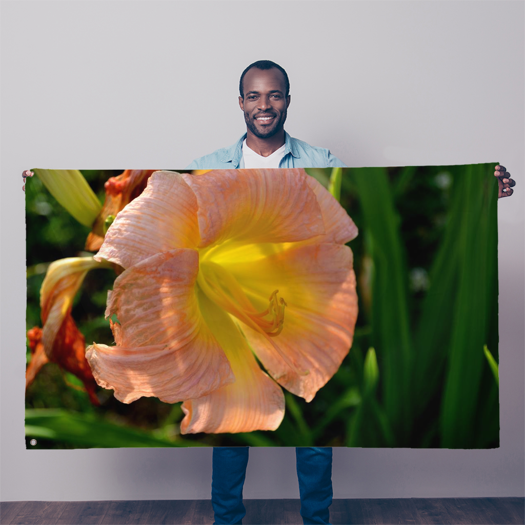 A vibrant orange flower sublimation flag, measuring 5FT X 3FT, made of durable polyester fabric with double-stitched edges and eyelets for hanging.