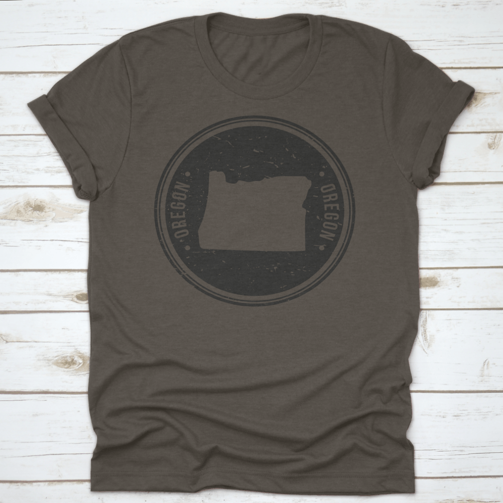 Oregon Map Symbol Round Design Stamp T-Shirt in Sport Grey, showcasing a unique map design.