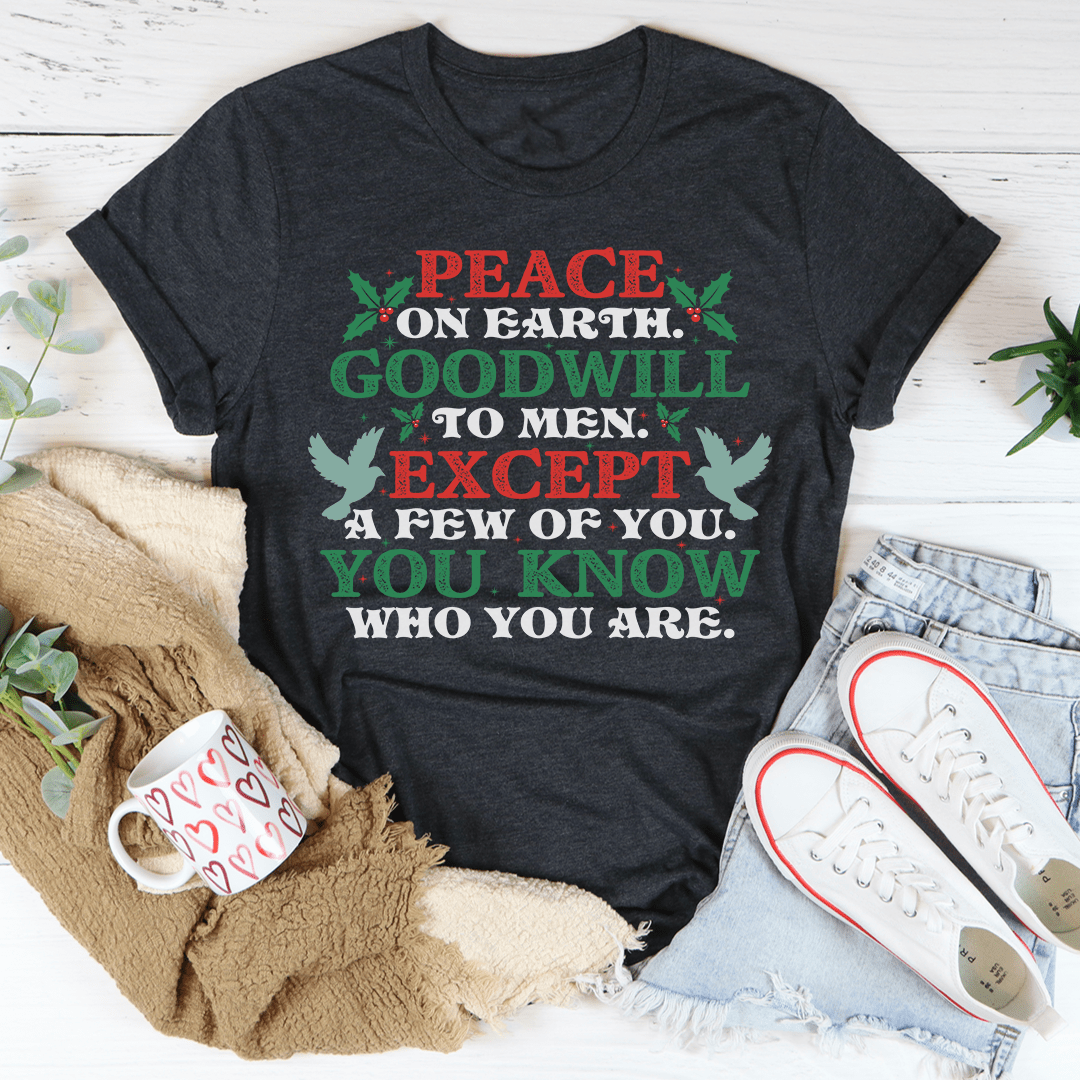A festive Peace On Earth Goodwill To Men Tee featuring a holiday-themed design, made from 100% soft cotton, perfect for Christmas celebrations.