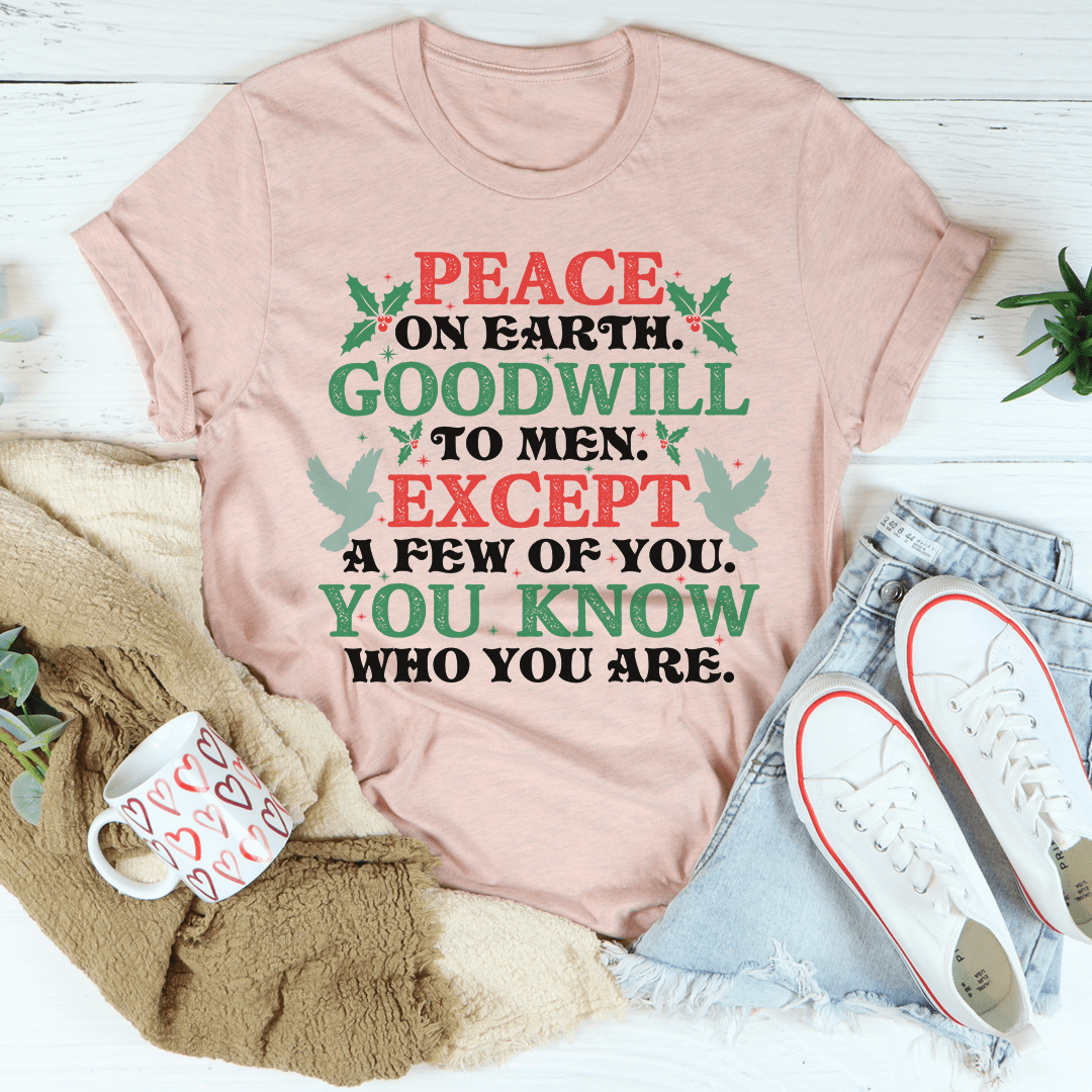 A festive Peace On Earth Goodwill To Men Tee featuring a holiday-themed design, made from 100% soft cotton, perfect for Christmas celebrations.