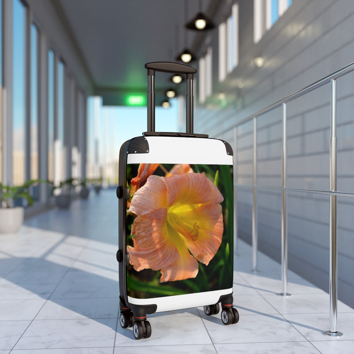 Peach and yellow floral patterned cabin suitcase with adjustable handle and wheels, perfect for stylish travel.